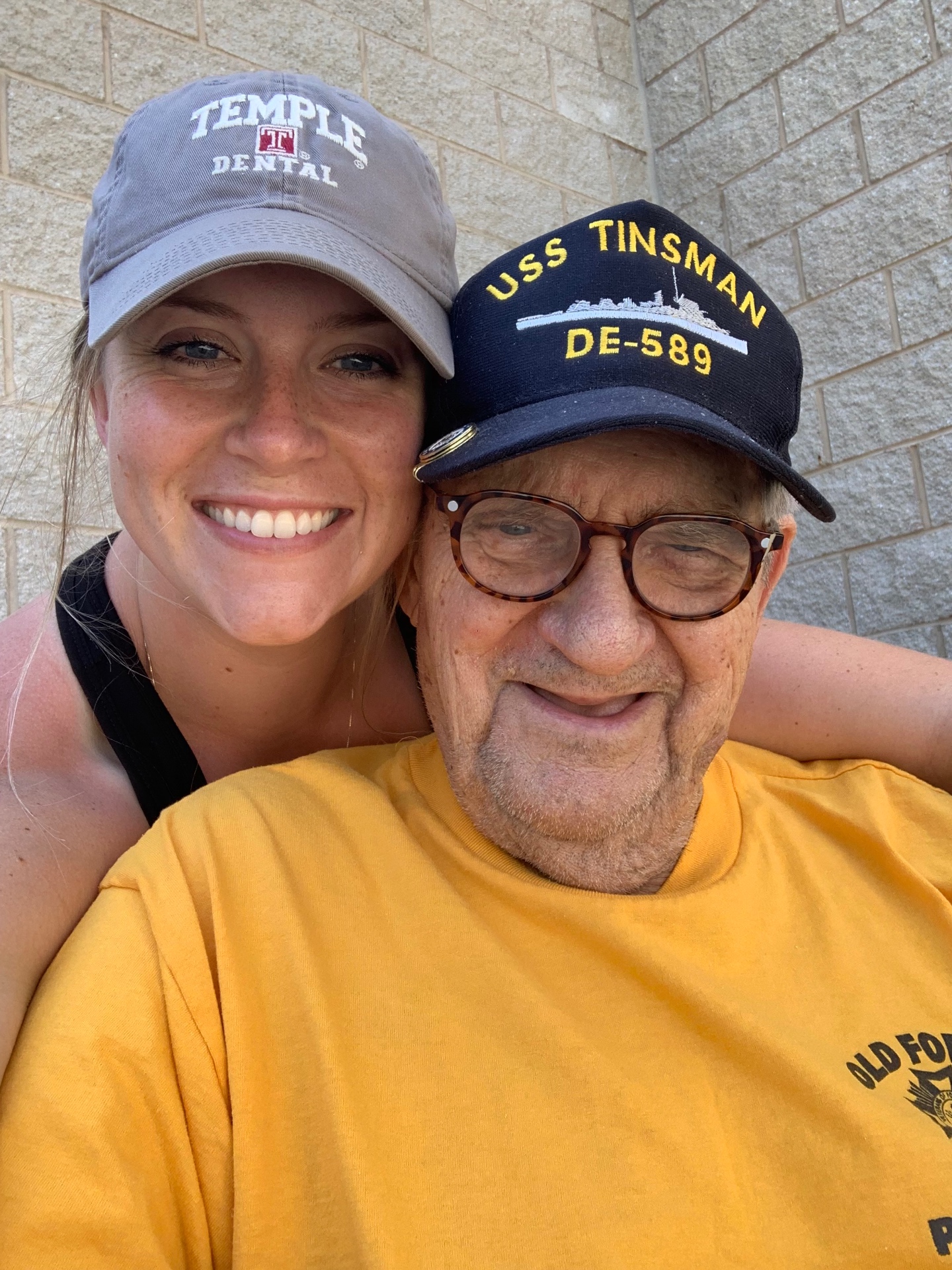 Britton with Grandpa Ted wearing his USS Tinsman cap