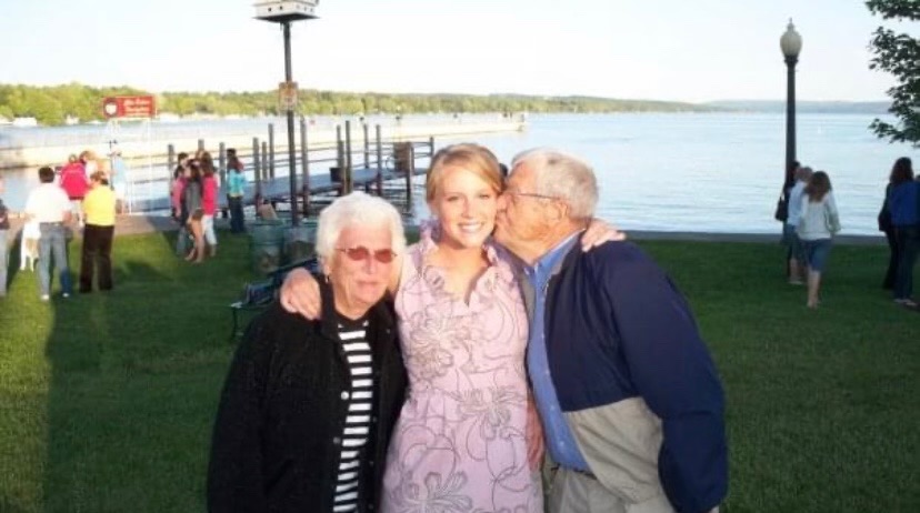 Britton with her grandparents beside the lake